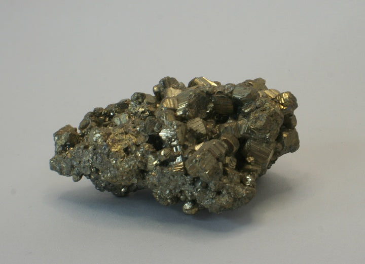 Pyrite cluster front view showing striations