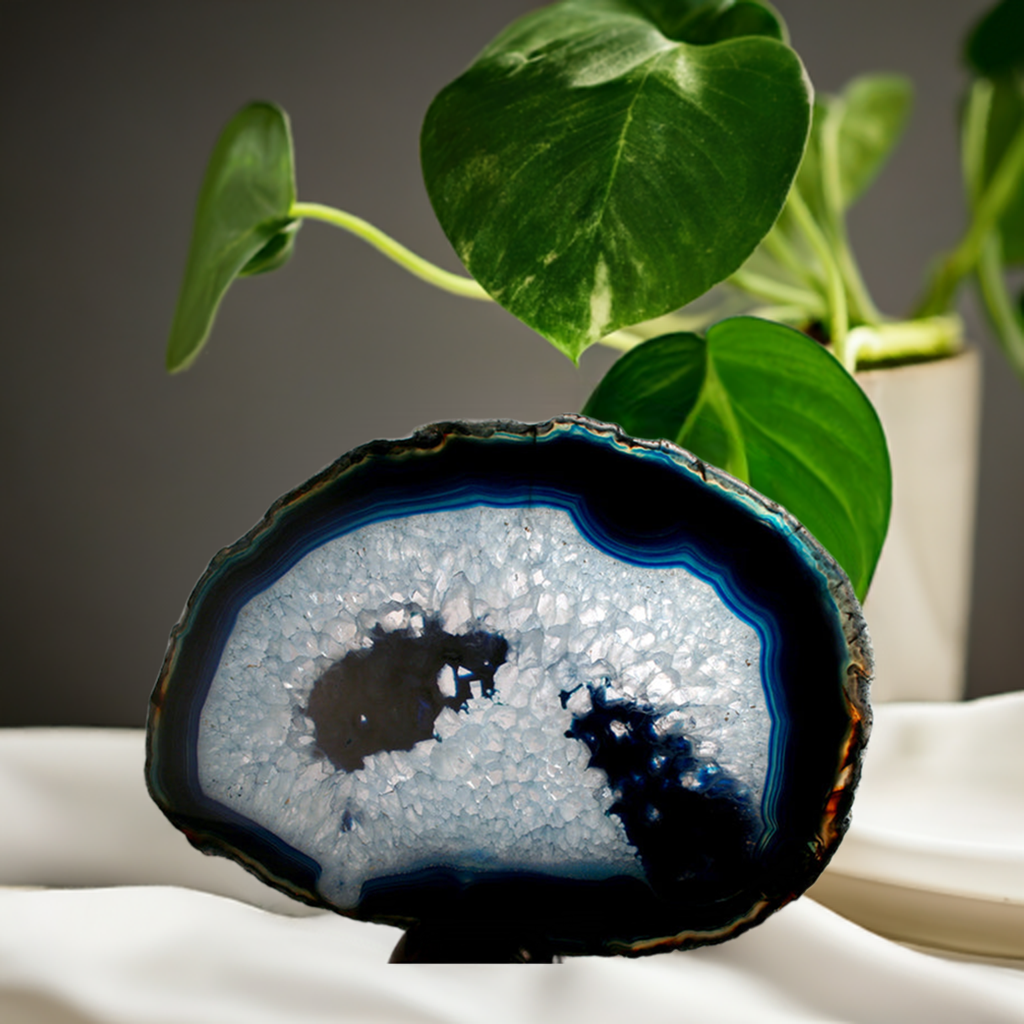 Blue and crystal slab sitting on a table with greenery in background