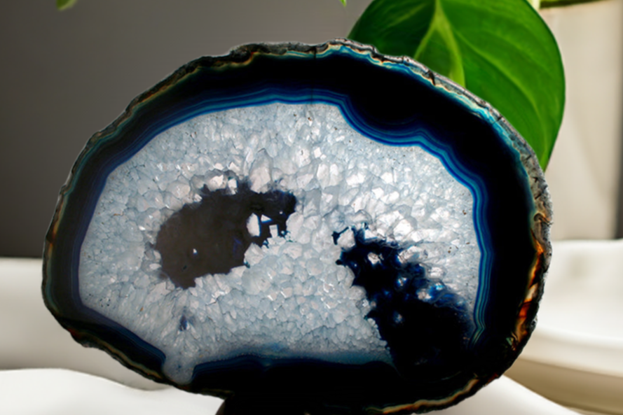 Blue and crystal slab sitting on a table with greenery in background